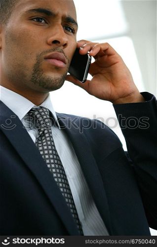 Serious businessman using a cellphone
