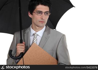 Serious businessman with an umbrella