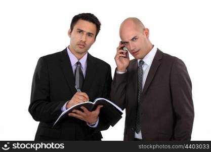 Serious businessmen with a cellphone