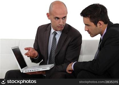 Serious businessmen with a laptop