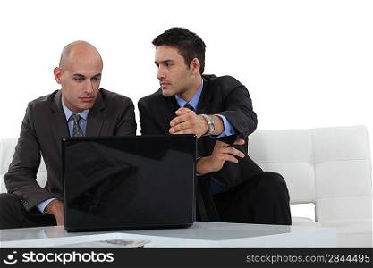 Serious businessmen with a laptop