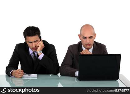 Serious businessmen working at a desk