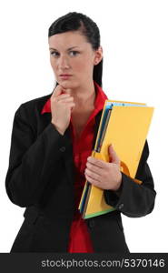 Serious businesswoman holding folders