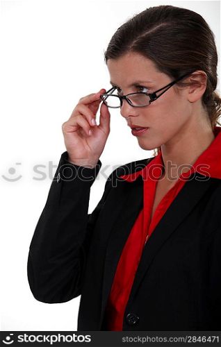 Serious businesswoman lifting glasses