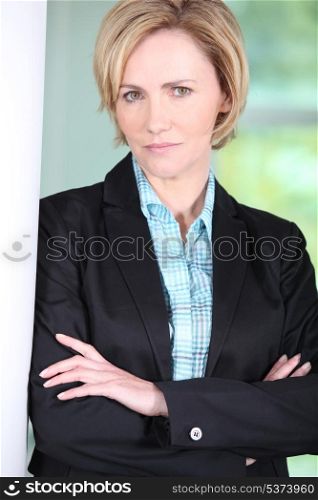 Serious businesswoman standing with arms crossed