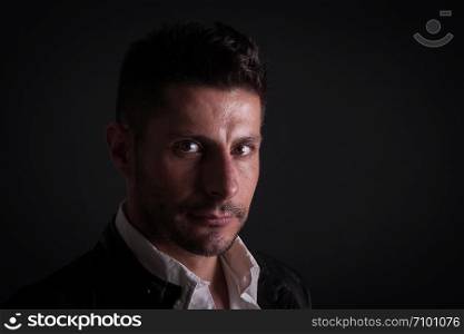 serious caucasian man on dark background