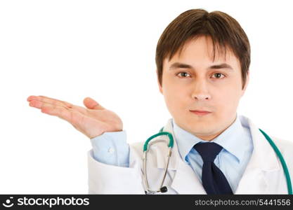 Serious doctor presenting something on empty hand isolated on white&#xA;