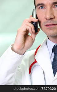 Serious doctor using a cellphone