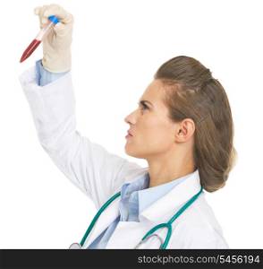 Serious doctor woman checking test tube