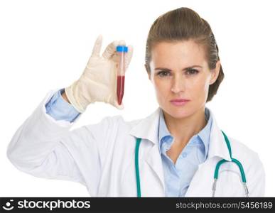 Serious doctor woman showing test tube