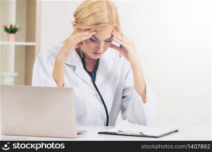 Serious doctor working in hospital office. Medical and healthcare concept.. Serious doctor working in hospital office.