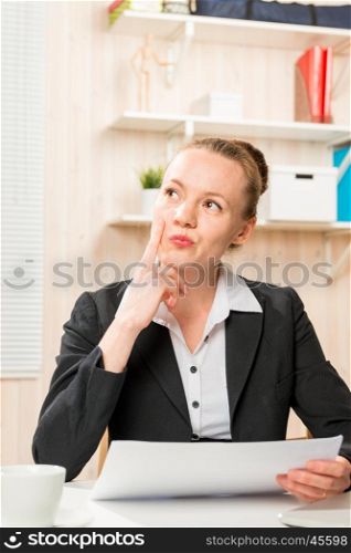 serious financial analyst with documents in the office thinking