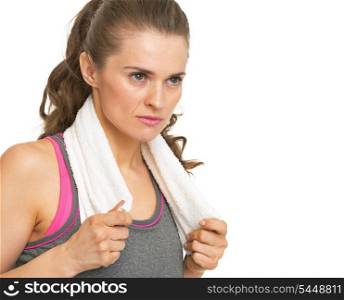 Serious fitness young woman with towel looking on copy space