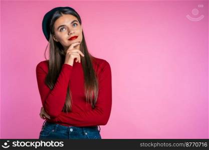 Serious girl in red wear. Portrait of young thinking pondering pretty woman on pink background.. Serious girl in red wear. Portrait of young thinking pondering pretty woman
