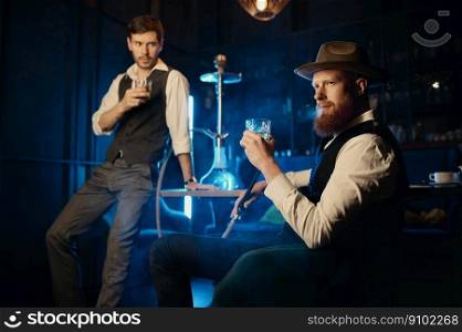Serious guys smoking hookah while rest in the pub. Male bachelor mafia party in restaurant concept. Serious guys smoking hookah while rest in the pub