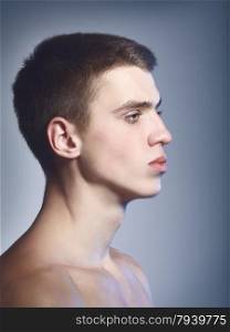 serious handsome young man, profile close up portrait