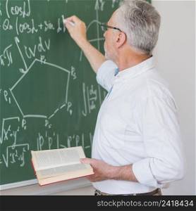 serious lecturer glasses chalking formula blackboard