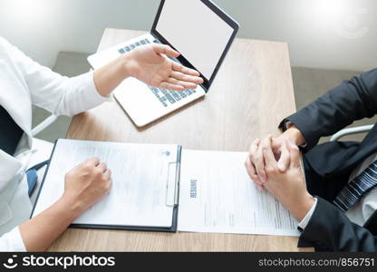 Serious man has a business meeting reading a resume about hiring decision during a job interview in company, attractive and professionally dressed, employment recruitment concept