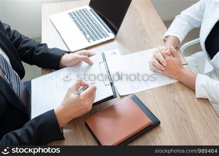 Serious man has a business meeting reading a resume about hiring decision during a job interview in company, attractive and professionally dressed, employment recruitment concept