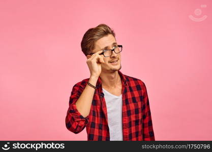 Serious man in glasses, pink background, emotion. Face expression, male person looking on camera in studio, emotional concept, feelings. Serious man in glasses, pink background, emotion