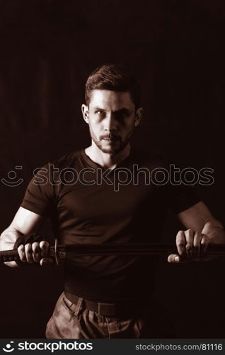 serious man in military style with weapon
