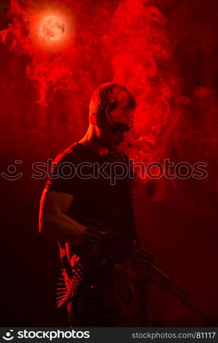 serious man in military style with weapon