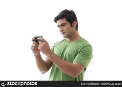 Serious man reading text message over white background