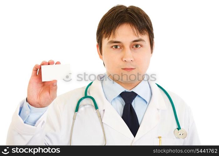 Serious medical doctor holding blank business card in hand isolated on white&#xA;
