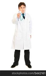 Serious medical doctor holding up stethoscope isolated on white&#xA;