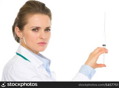 Serious medical doctor woman holding syringe