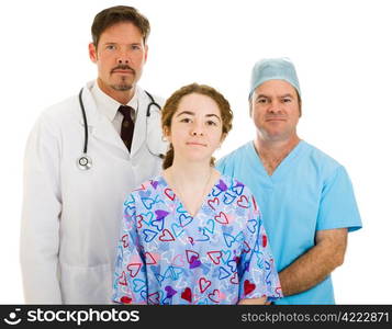 Serious medical team - doctor, surgeon, and nurse - isolated on white background.