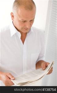 Serious senior businessman professional portrait read newspapers white shirt