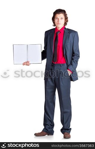 Serious student stands with notebook in gray suit and red shirt on white background