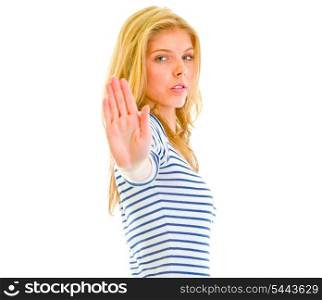 Serious teen girl showing stop gesture isolated on white &#xA;