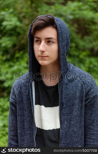 Serious teenager guy with hood on the head
