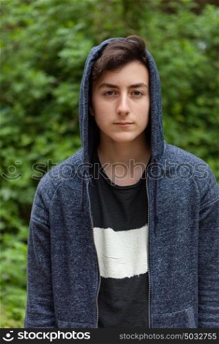 Serious teenager guy with hood on the head