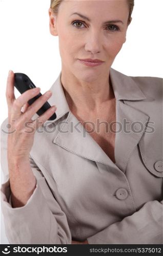 Serious woman holding a mobile phone