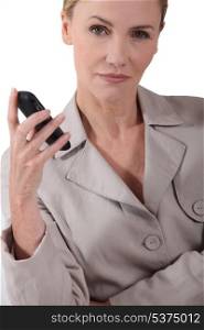 Serious woman holding a mobile phone