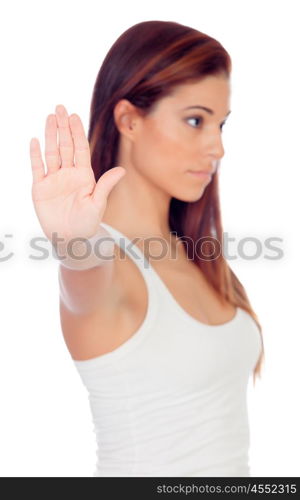 Serious woman making a stop sign with her hand isolated on a white background