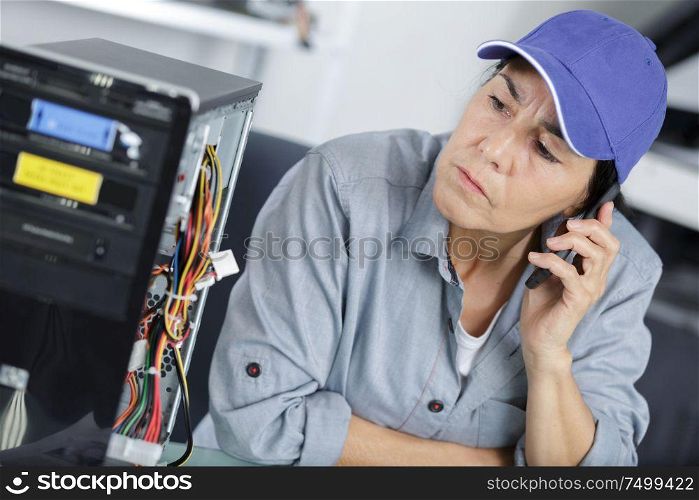 serious woman on phone in busy modern office