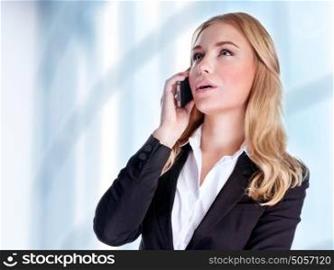Serious woman talking on mobile phone near office building, professional conversation, smart businesspeople concept