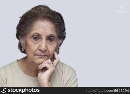 Serious woman thinking over white background