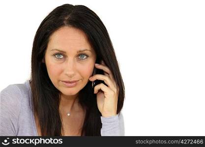 Serious woman using a cellphone
