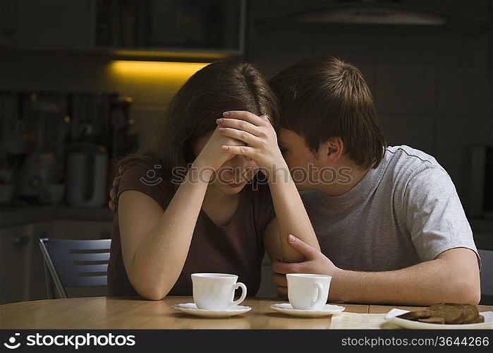 Serious young couple woman with head in hands