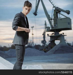 Serious young guy in industry area