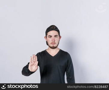Serious young man stop sign with palm, caucasian man stop sign with hand, stop concept with hand