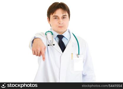 Serious young medical doctor pointing finger down isolated on white&#xA;
