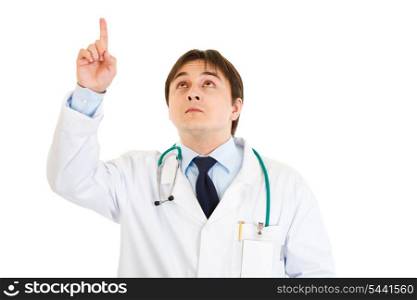 Serious young medical doctor pointing finger up isolated on white&#xA;