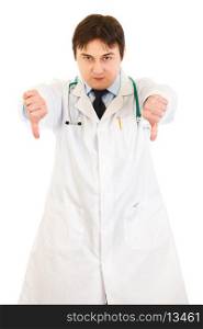 Serious young medical doctor pointing fingers down isolated on white&#xA;