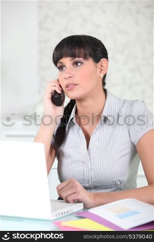 Serious young woman on the telephone